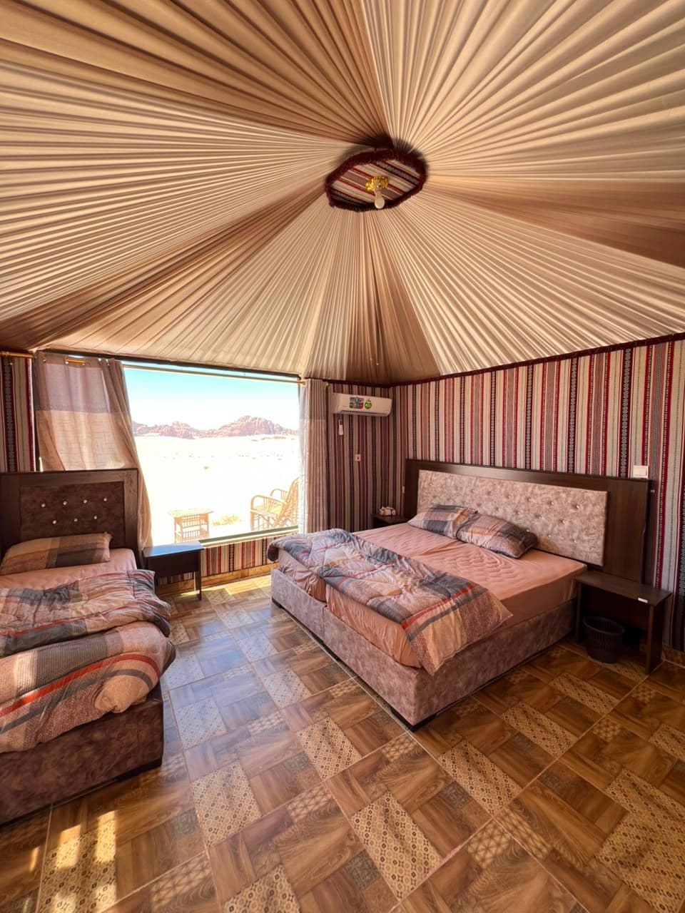 Panoramic triple room inside Bedouin tent overlooking Wadi Rum dunes